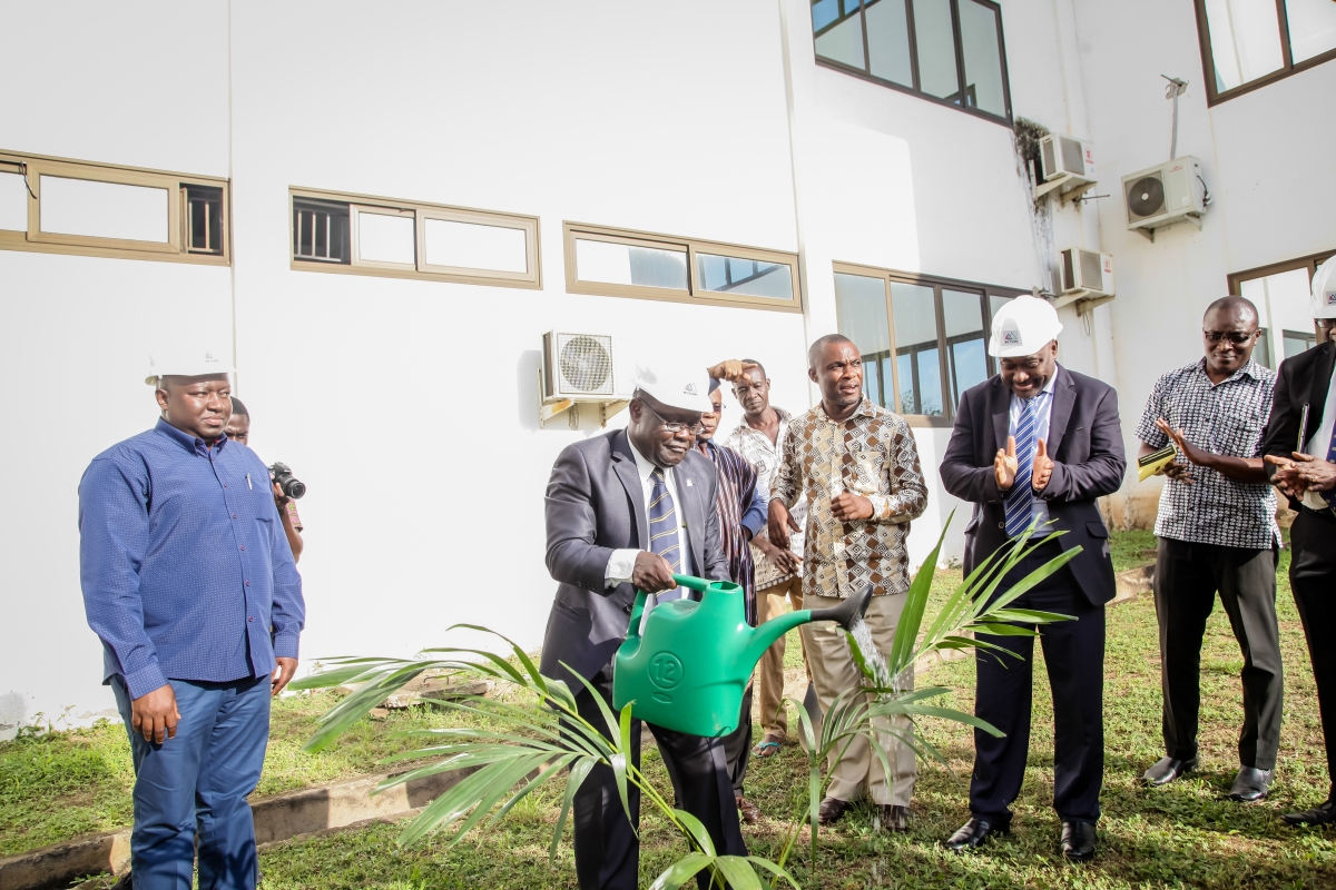 Vice Chancellor watering a tree planted on the site 